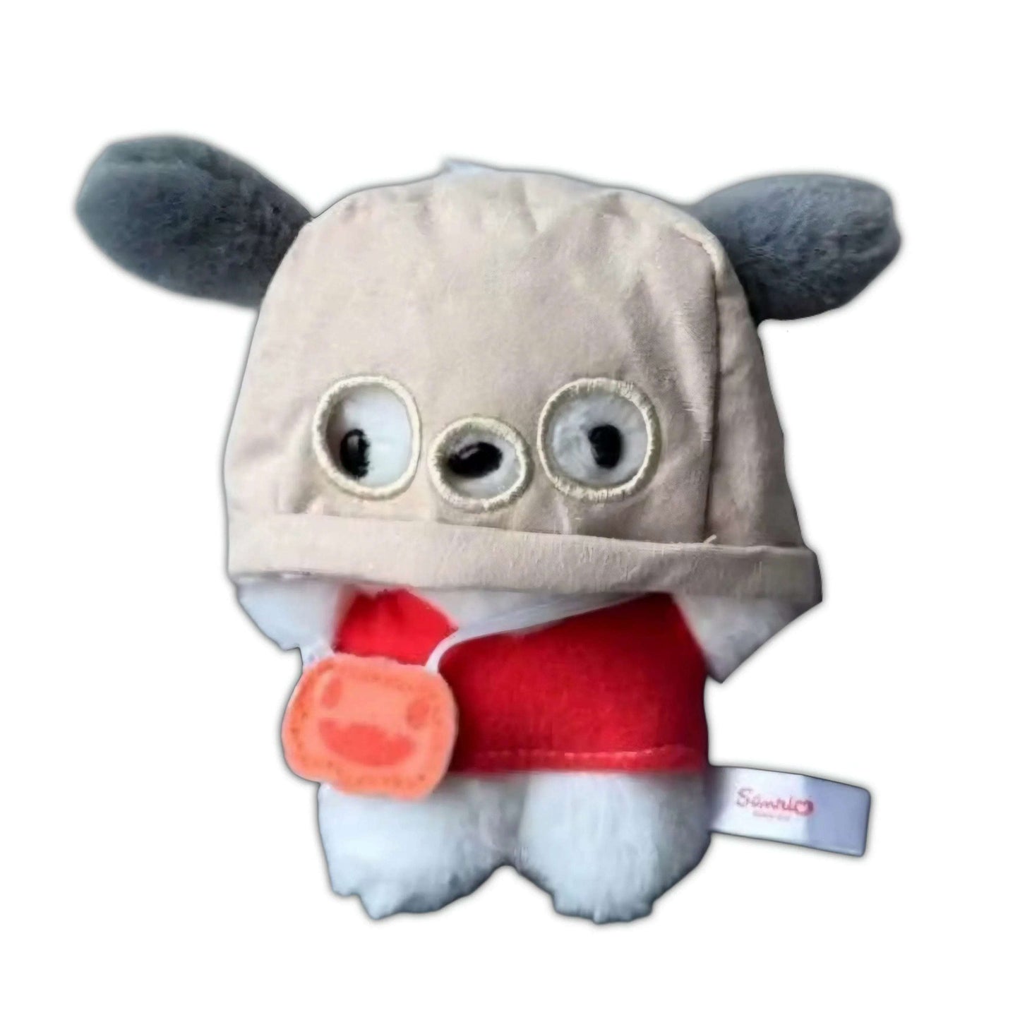 Light gray plush mask keychain with round eyes, red hood, orange charm