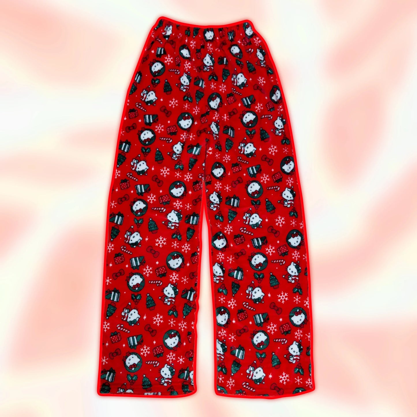 Red pajama pants with holiday penguin print and snowflake motifs, wide straight legs