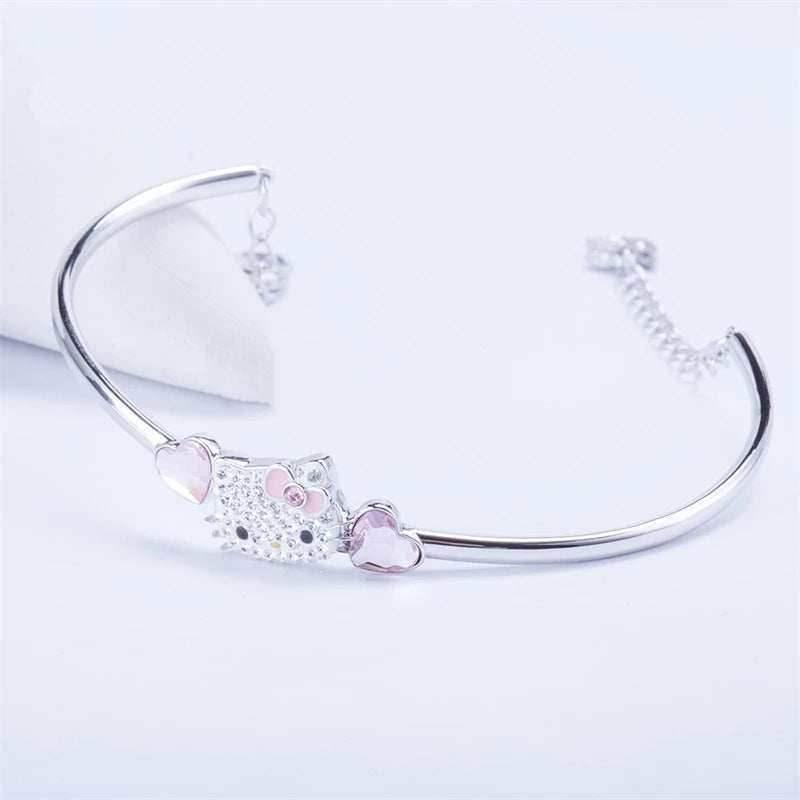 Silver open bangle bracelet with Hello Kitty face center and pink heart drop charms