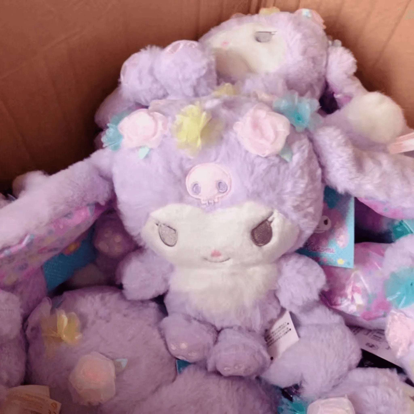 Floral bunny plushie—purple bunny with pastel flower accents and embroidered face