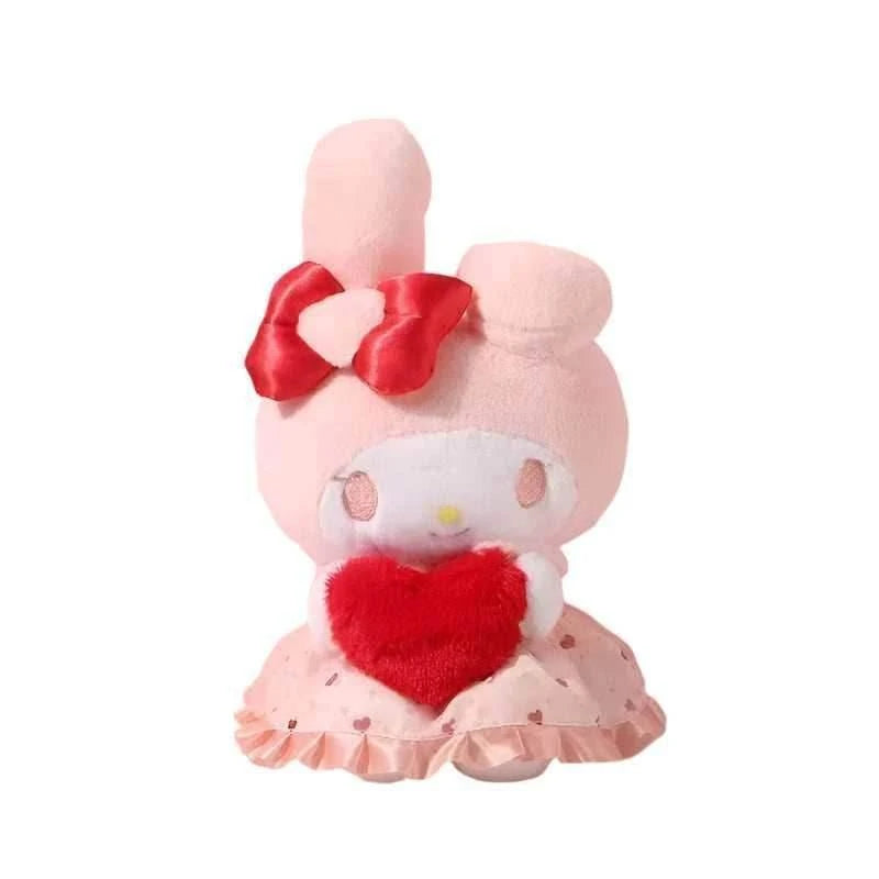 Pink plush toy with red heart chest, red bow on ears, and ruffled skirt