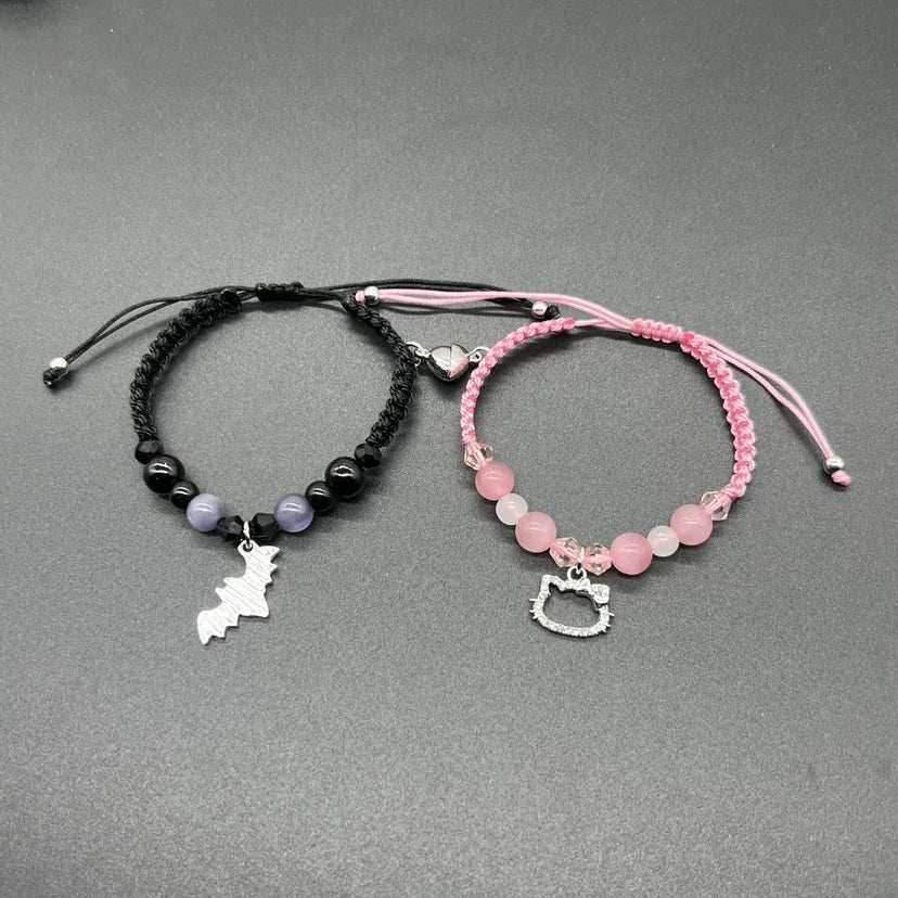 Bracelet set of 2: black bead strand with bat charm, pink bead strand with cat charm