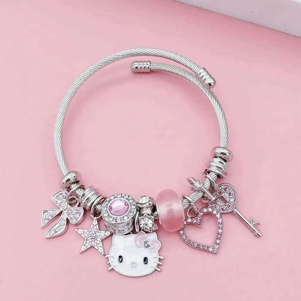 Silver charm bracelet with Hello Kitty face, heart charms, pink bead, and star details