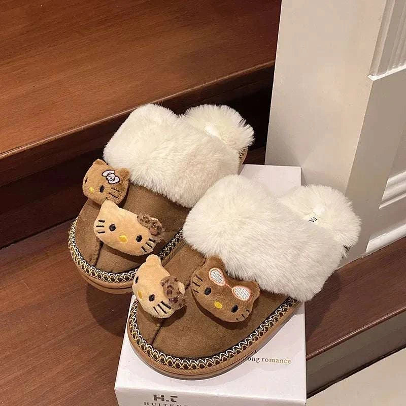 Brown plush mini slippers with fluffy cream cuffs and cartoon cat-face graphics in box
