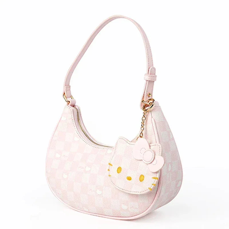 Pink checkered shoulder bag with front Hello Kitty face detail and dangling charm
