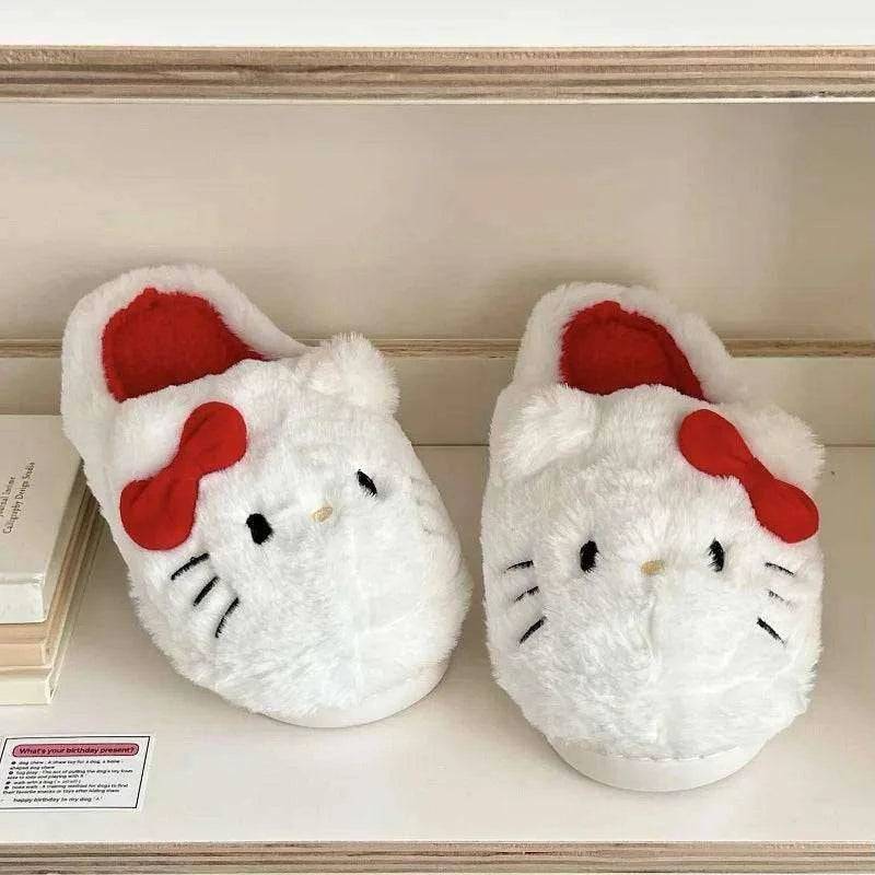 White plush Hello Kitty slippers on a shelf with red bows and red interiors