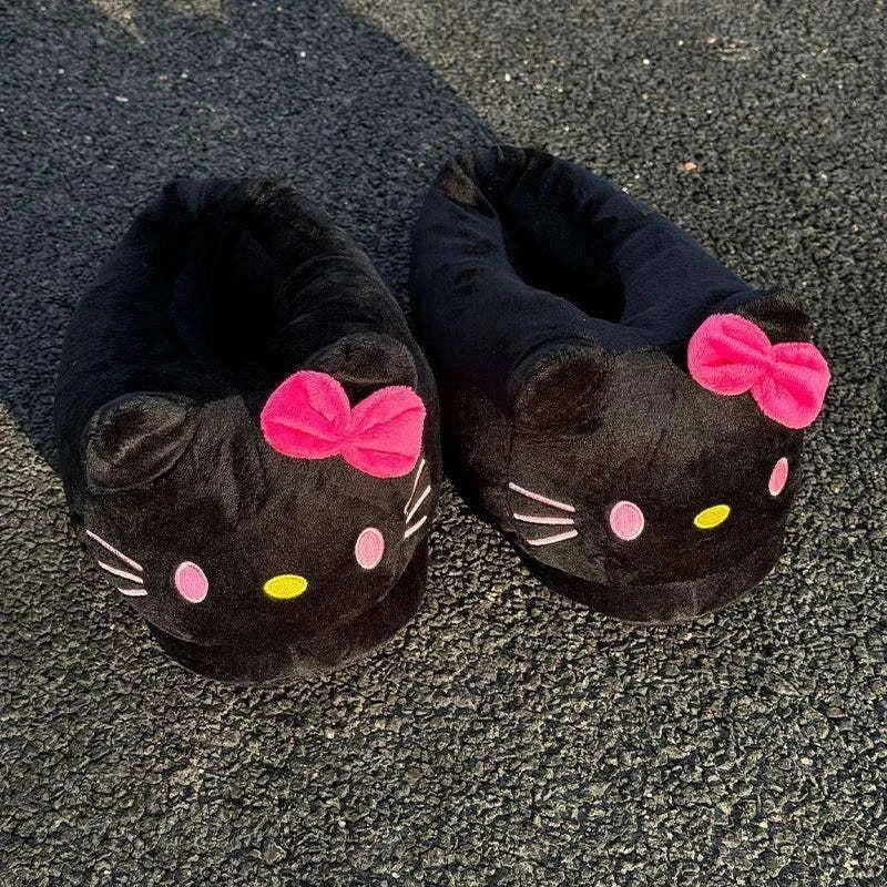 Black plush slippers with pink bows and cat-face embroidery on textured floor