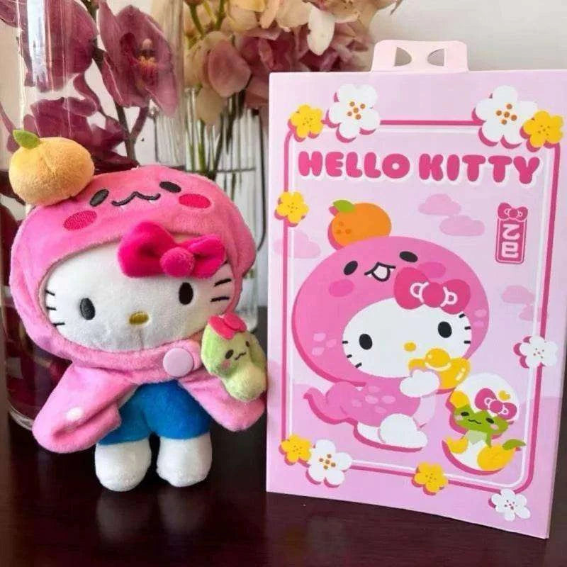 Hello Kitty year of the snake keychain plush in pink hood, blue pants, holding green snake