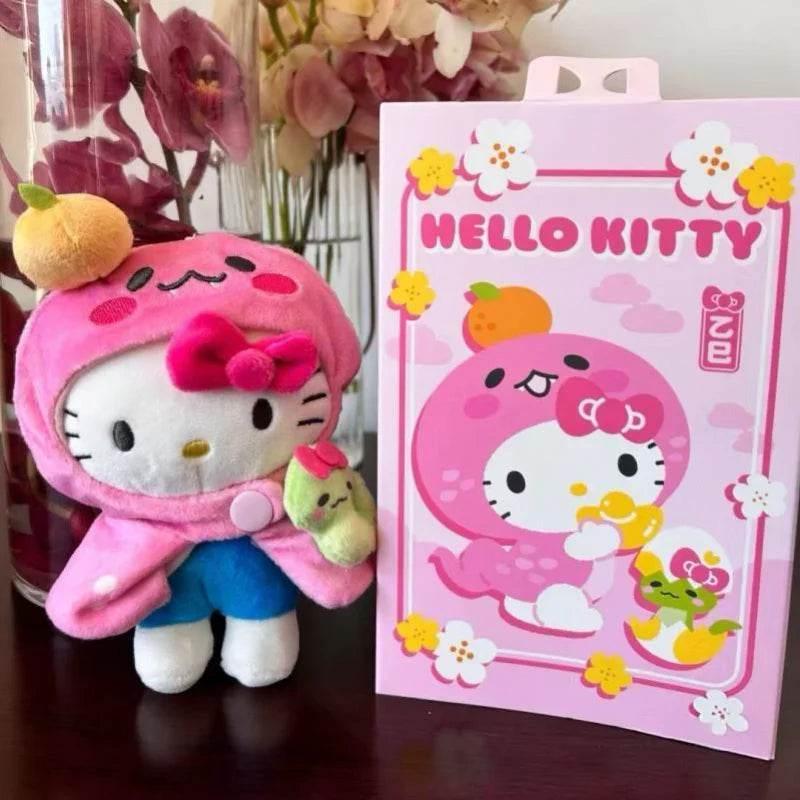 Pink plush cat keychain with hood, holding green snake charm, boxed