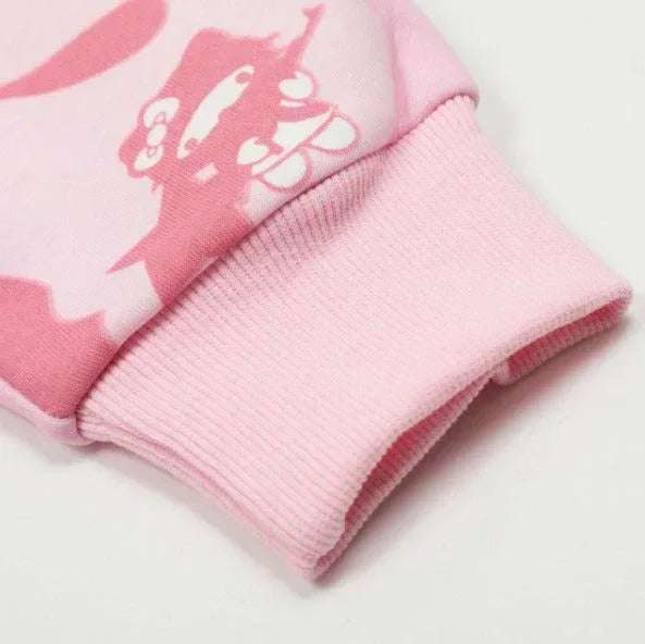 Pink zip-up hoodie sleeve cuff close-up with ribbed knit hem and printed detail