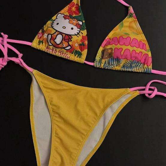 Yellow printed triangle bikini with pink trim, string ties, and character graphic