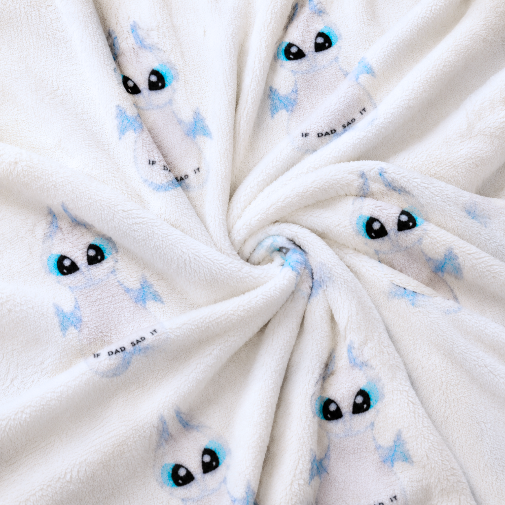 White fleece pajama fabric with blue dragon-face print and black eyes