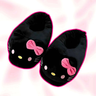 Black plush slippers with pink bows and cat-face details, two-shoe close-up