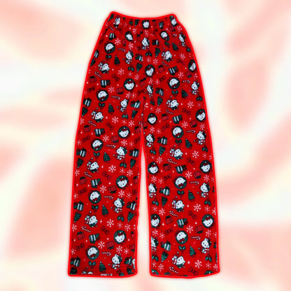 Red pajama pants with holiday penguin print and snowflake motifs, wide straight legs