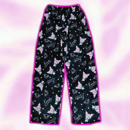Black pajama pants with pink and white character print, wide straight fit