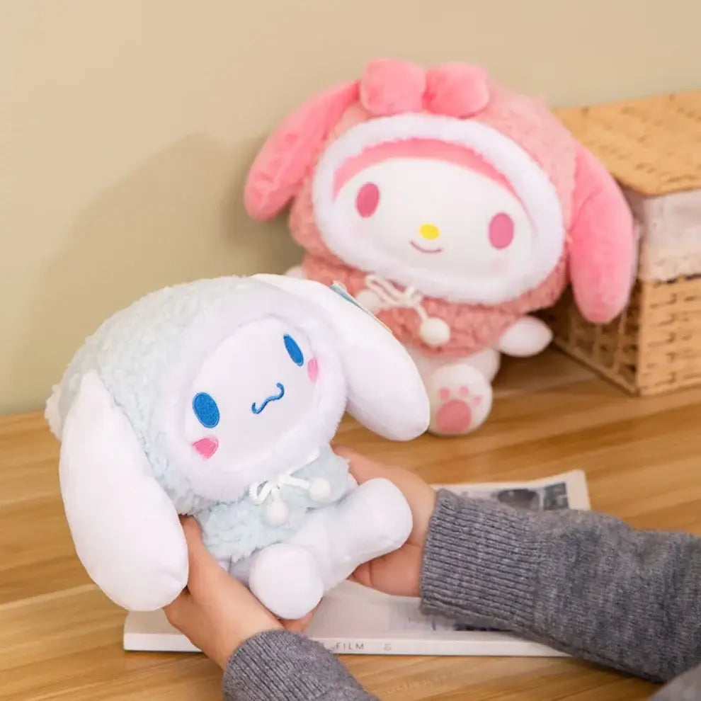 Pink and white plush hooded winter jacket toys with character faces on a shelf