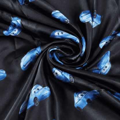 Thin pajama pants fabric with dark background and blue Lightning McQueen characters