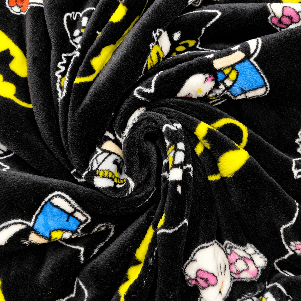 Black fleece pajama fabric with scattered character prints in yellow, blue, and pink.