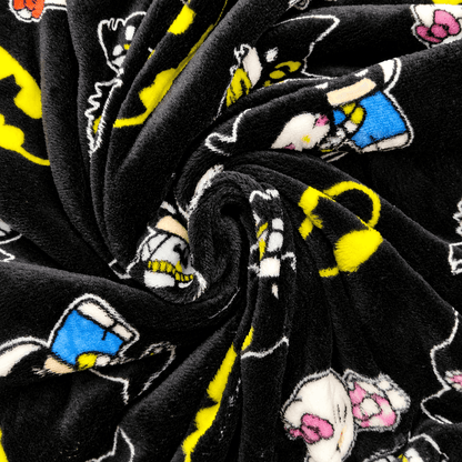 Black fleece pajama fabric with scattered character prints in yellow, blue, and pink.
