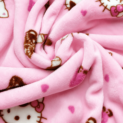 Pink plush pajama pants fabric closeup with Hello Kitty icons and hearts