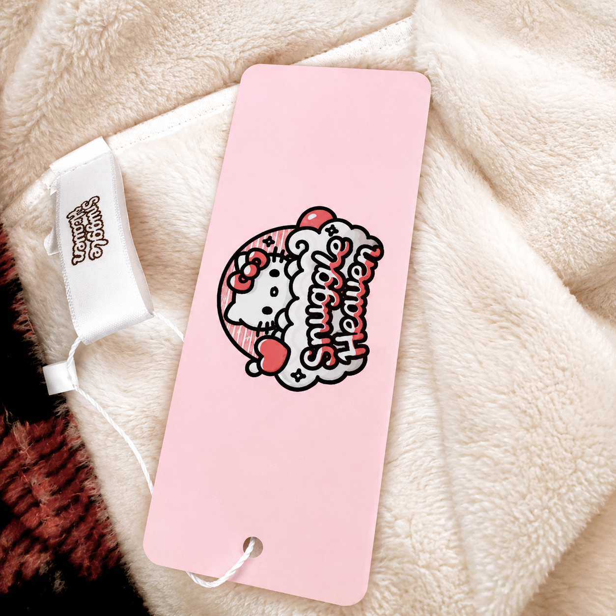 Soft cream plush fabric with pink hang tag and graphic logo