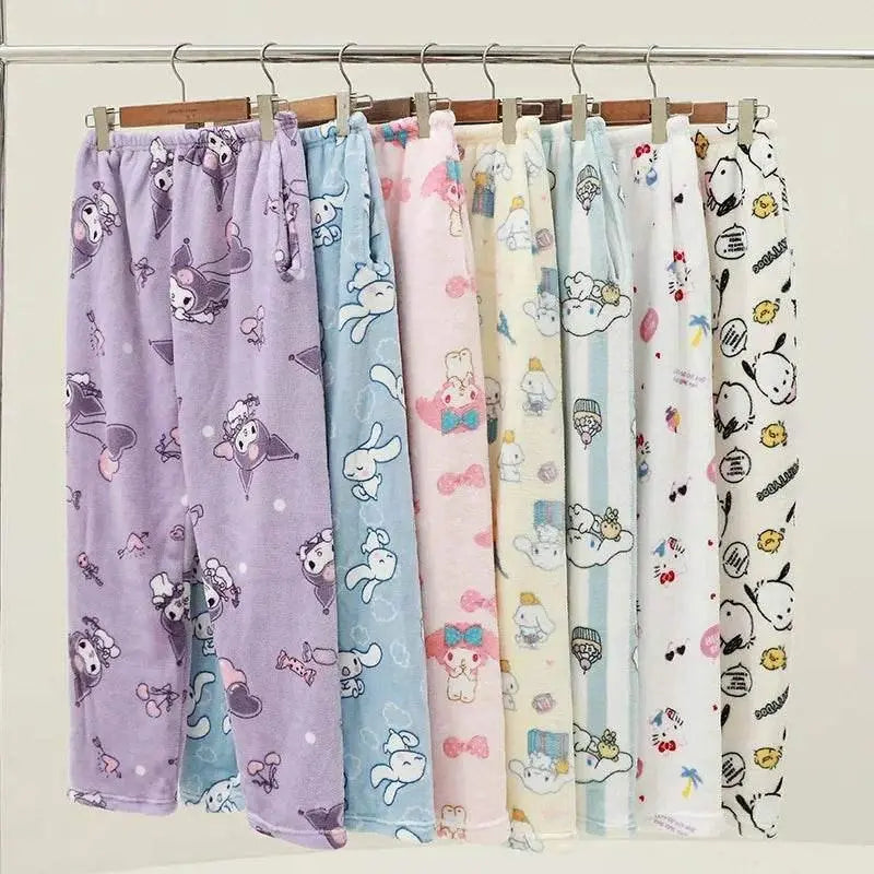 Assorted character pajama pants hanging on a rack, with elastic waistbands and all-over prints