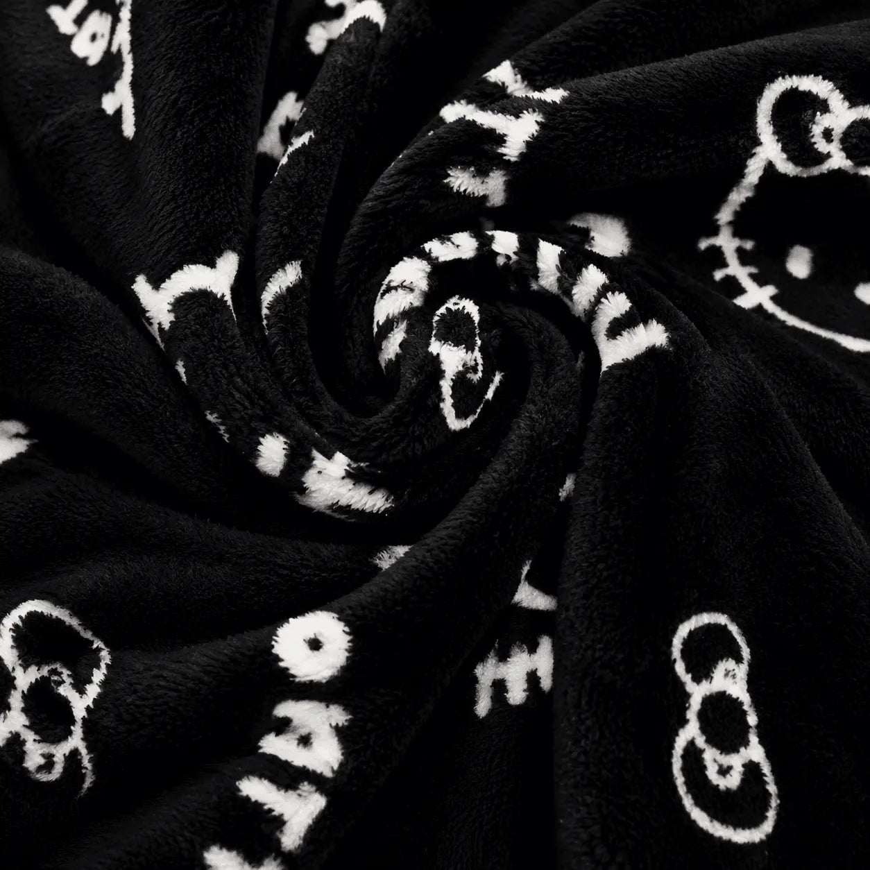 Black plush pajama fabric with white Hello Kitty icons and script print