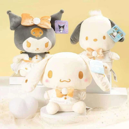 Two plush characters: dark gray skull-themed plush with orange bow and white plush with gold spots