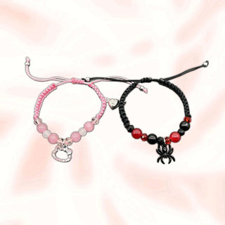 Two cord charm bracelets: black/red beads with spider charm, pink beads with heart tag